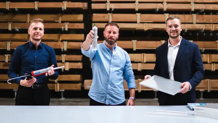 Mitarbeiter von mejo und der GLUETEC GROUP stehen im mejo Lager